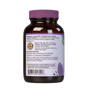 A dark amber bottle of Bluebonnet's Cinnamon Bark Extract dietary supplement, showing the back of the bottle with a purple cap and white label containing text and a barcode.