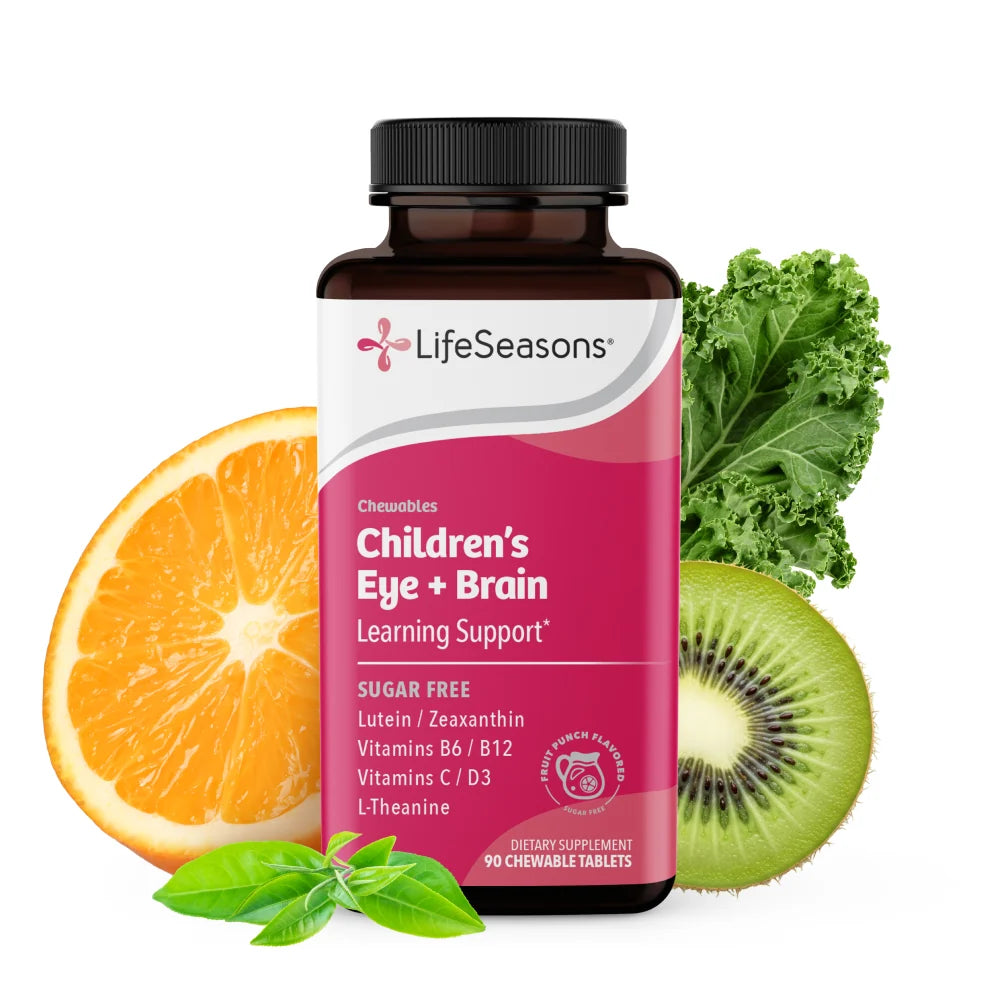 LifeSeasons Children's Eye + Brain supplement bottle centered on a white background, surrounded by fresh orange slices, kiwi, kale, and basil leaves.