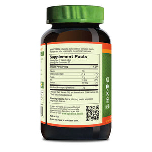 Supplement bottle with green cap and label on a white background